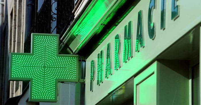 Green pharmacie sign with cross in France