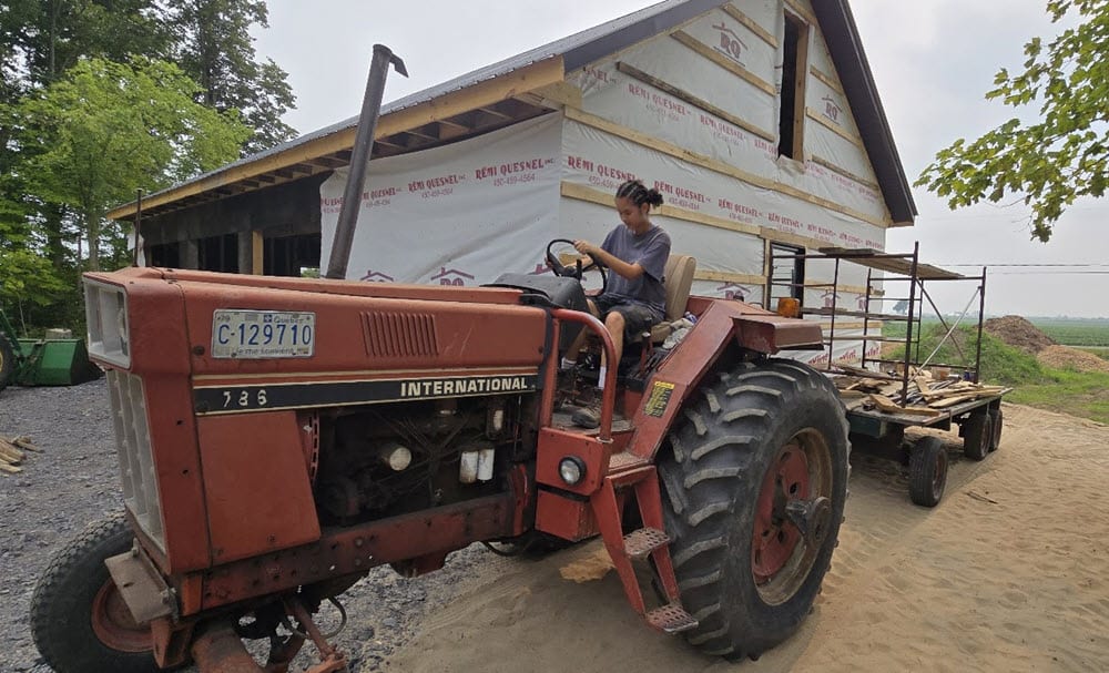 Annie André's daughter Catherine helping her French-Canadian cousin build a garage in St. Clet, rural Quebec