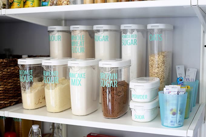 An organized pantry with labeled containers.