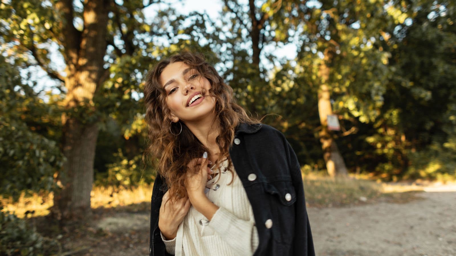 A likeable looking woman standing out in nature.