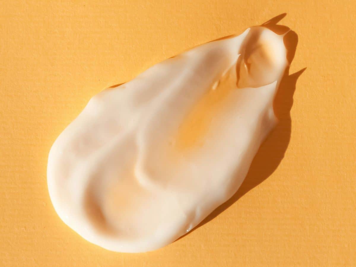 A white cream on a yellow background.