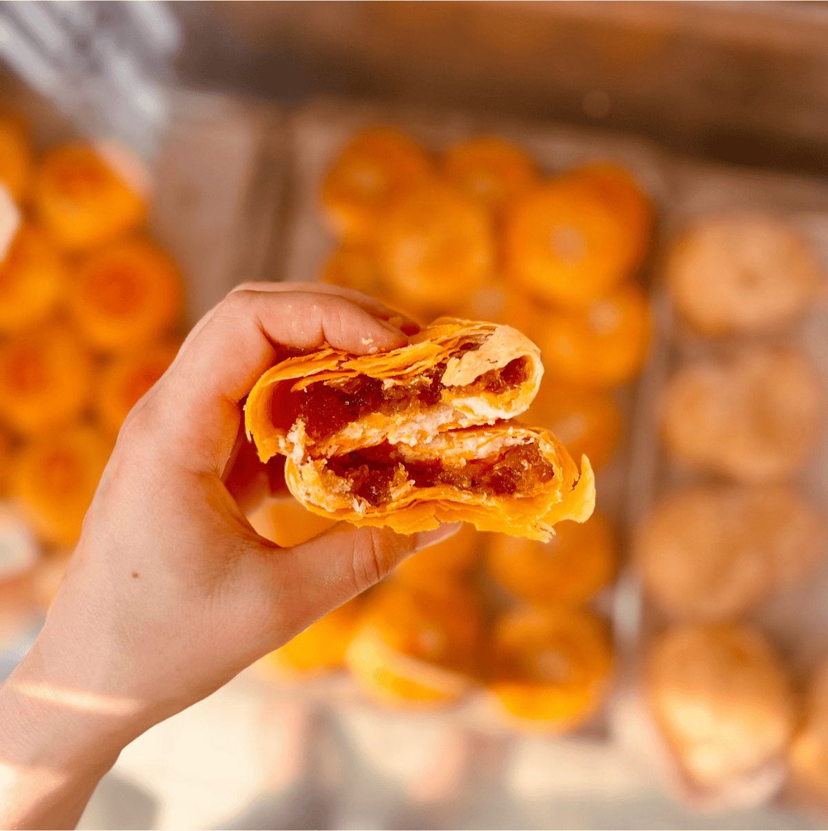 A hand holding a Chinese sweet.