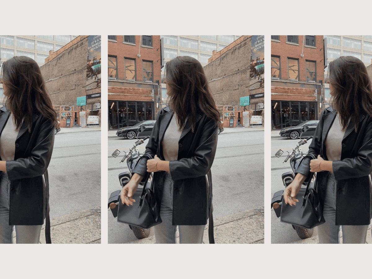 An attractive woman standing by a city street.