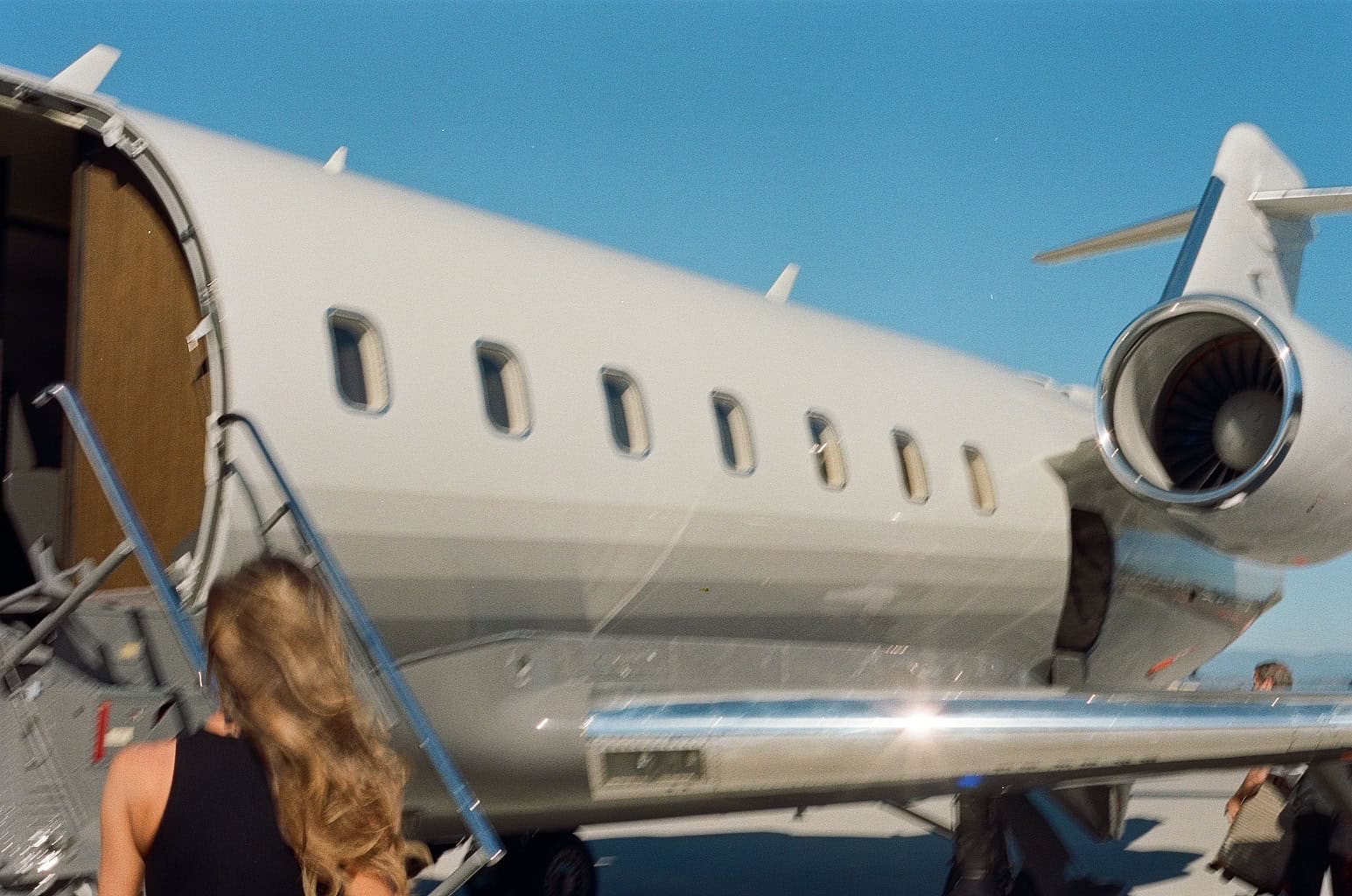 Woman getting on a plane.