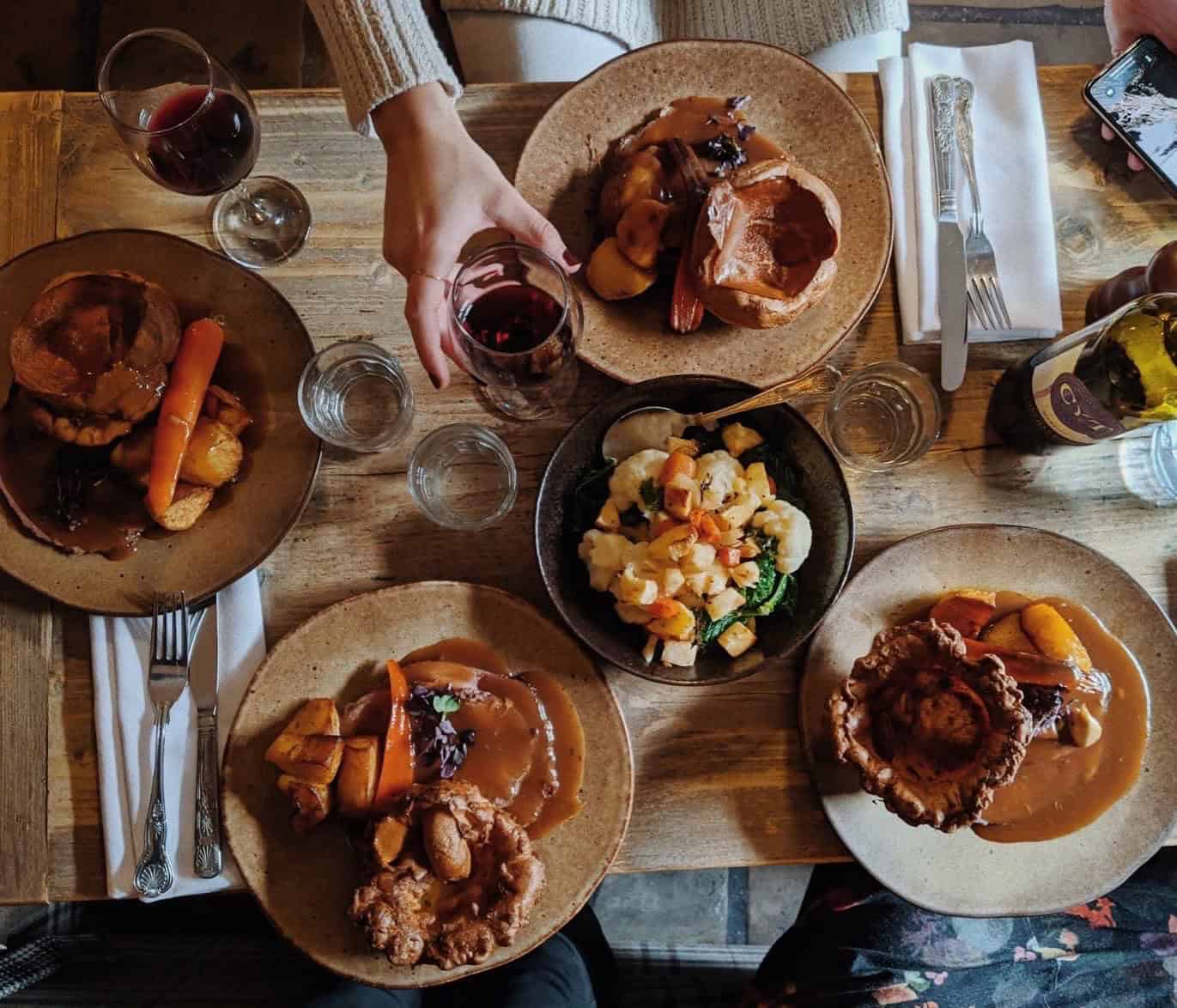 A holiday dinner on a wood table.