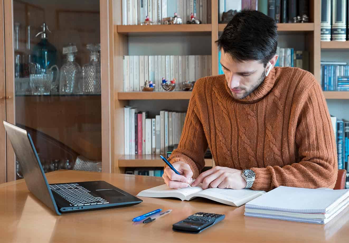 person studying from home with laptop