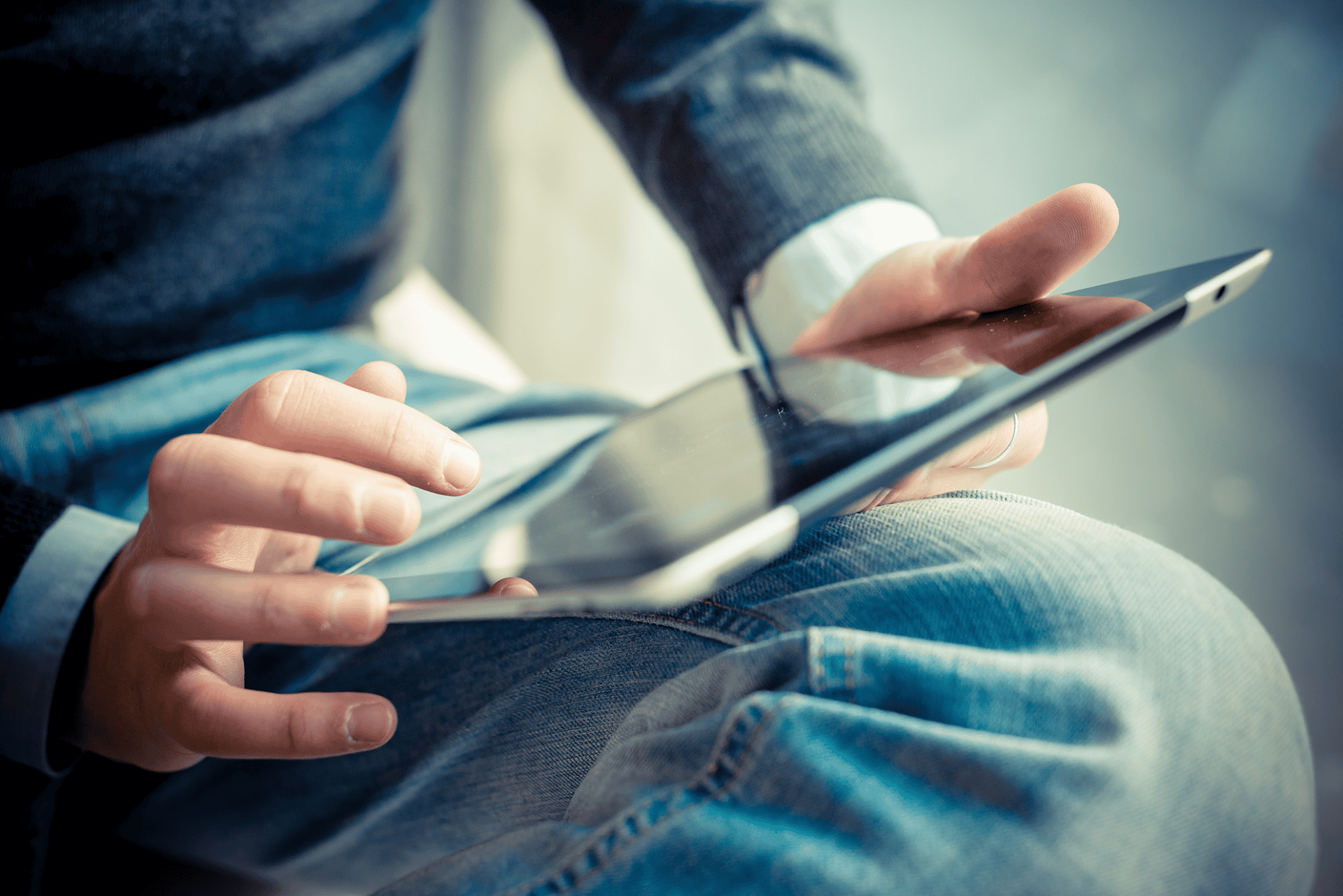 person using tablet up close