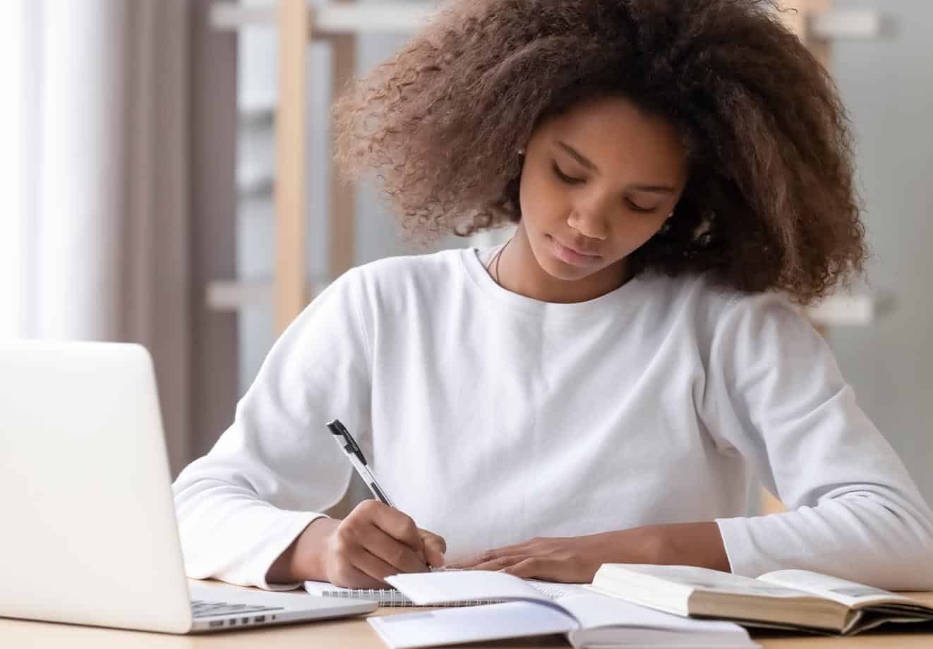 girl-wearing-white top-writing-on-notebook