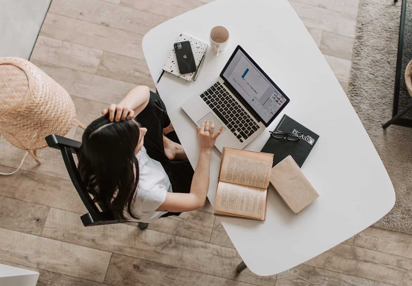 Woman sitting at table with laptop