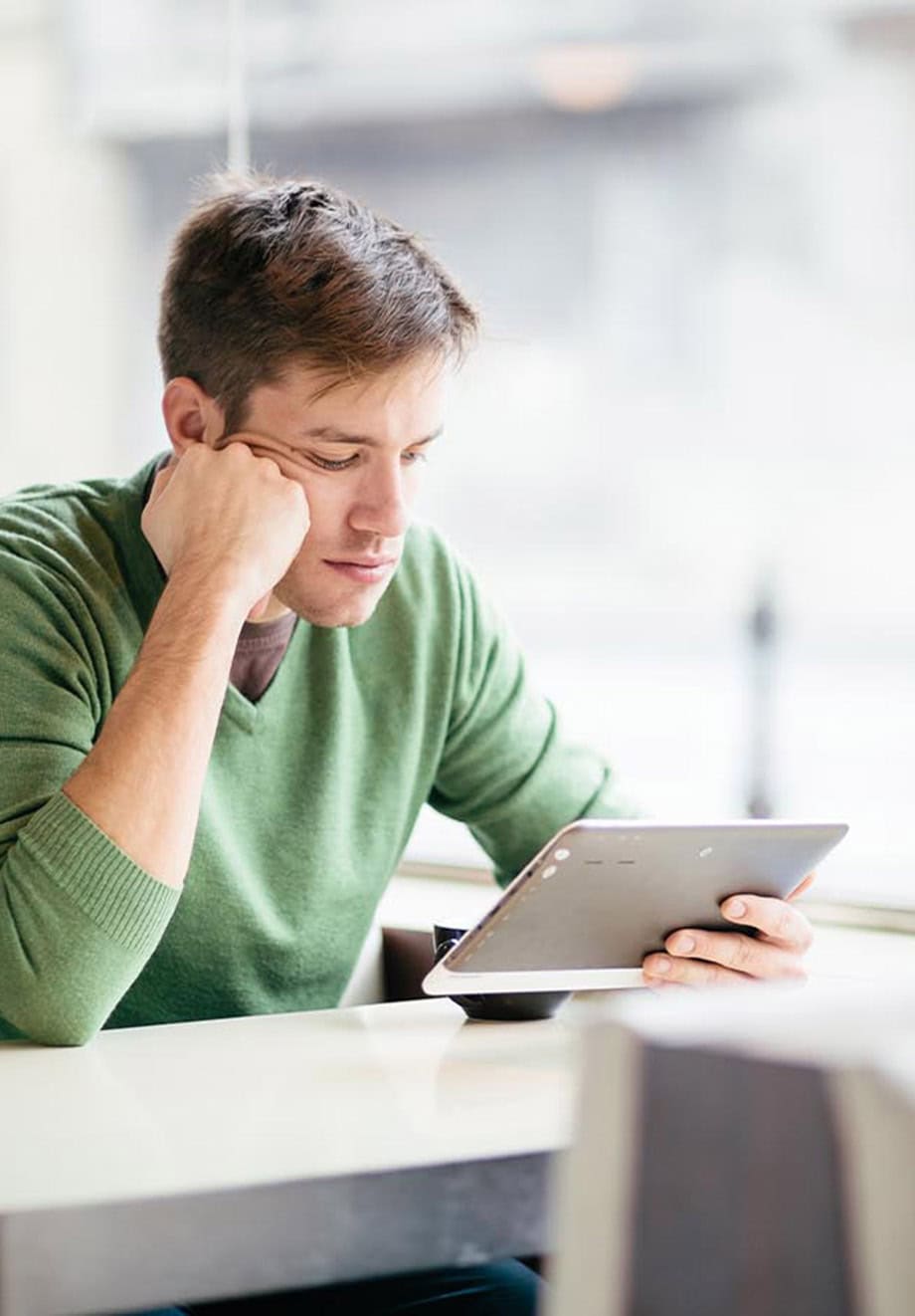 adult male student uses tablet to study