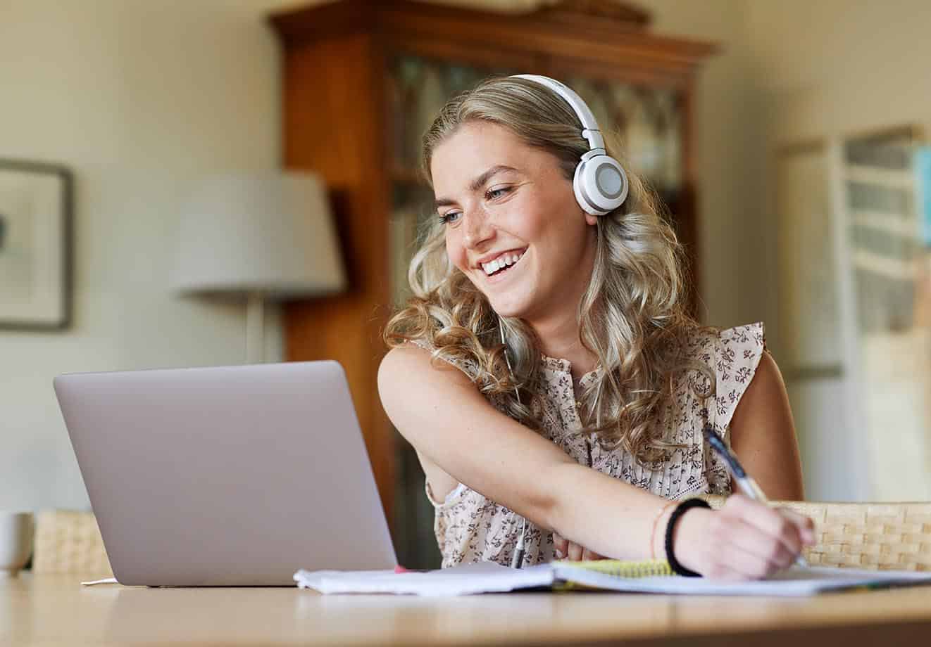 higher ed student studies on her laptop from home as her college has a hybrid learning model