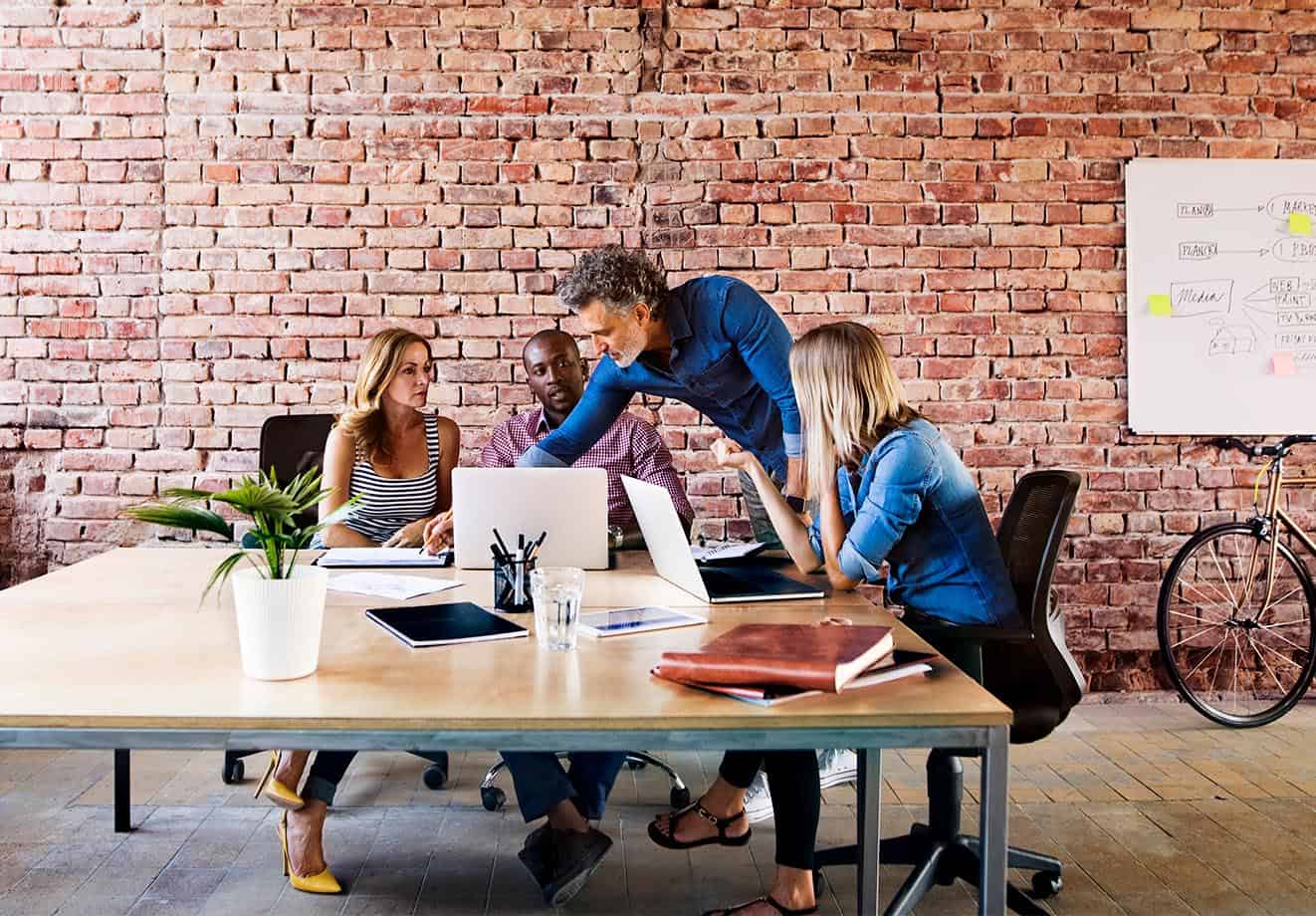 Group of people sitting around a table and talking