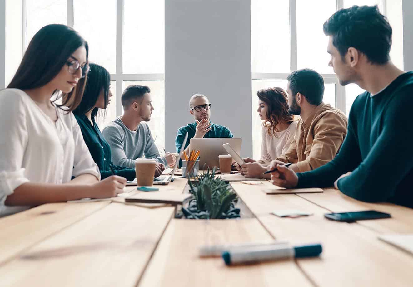 A group of staff meeting at a table.