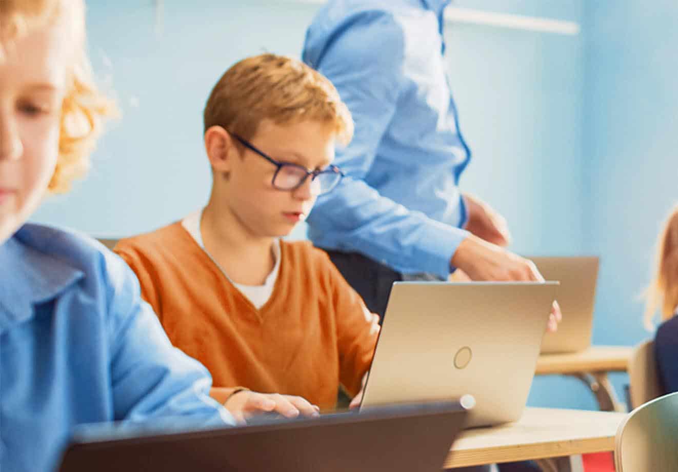 boy-wearing-orange-tshirt-looking-at-laptop-screen