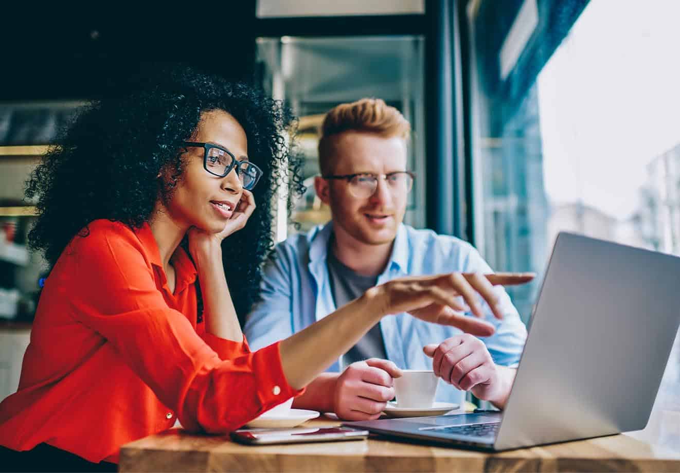 Two people looking at a laptop screen