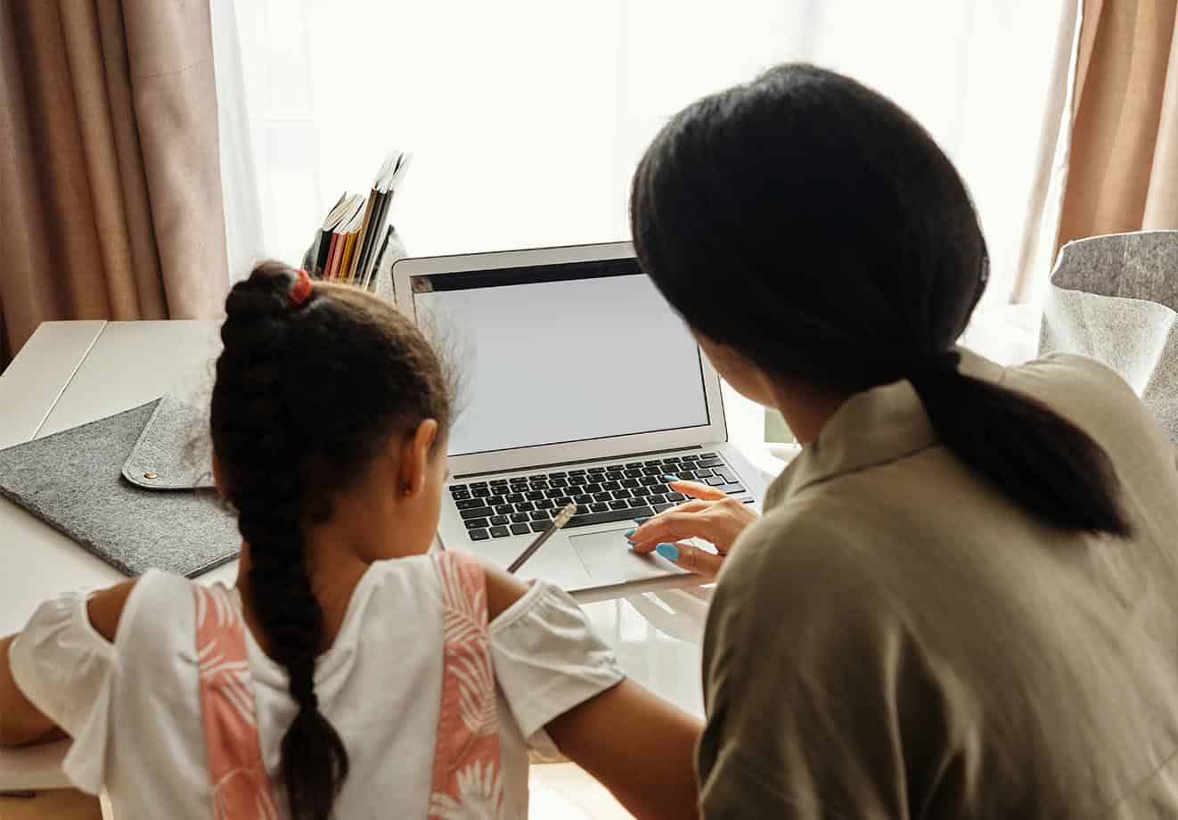 girl and mom learning on a laptop