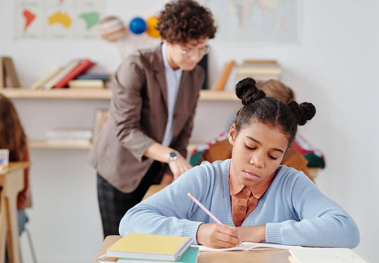 student working in workbook and looking concerned