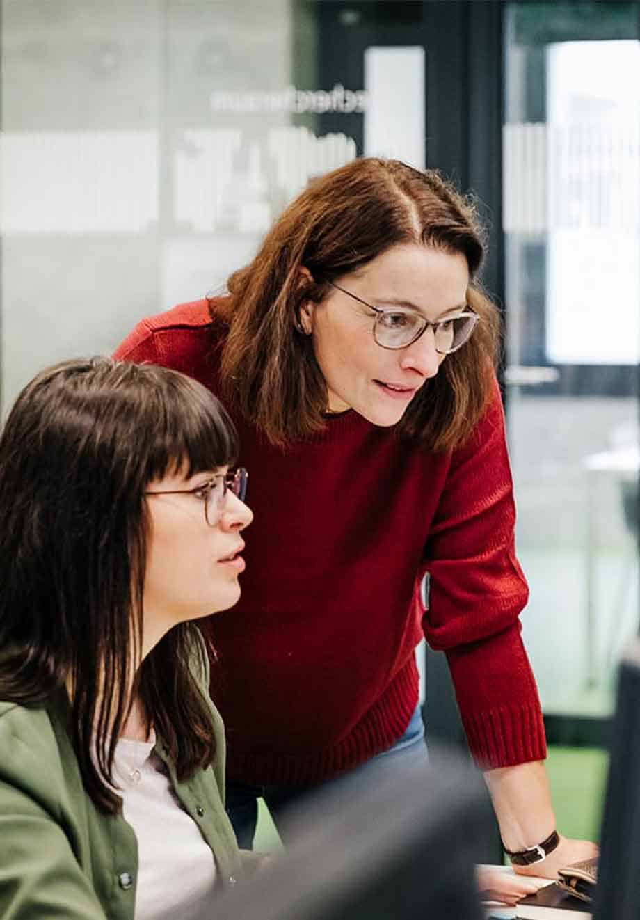 faculty helping a student in lab