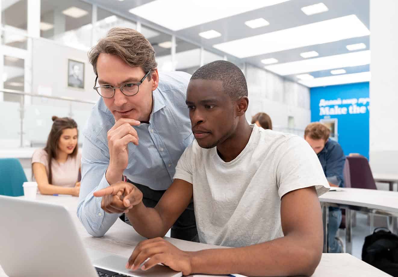Two people looking at a computer
