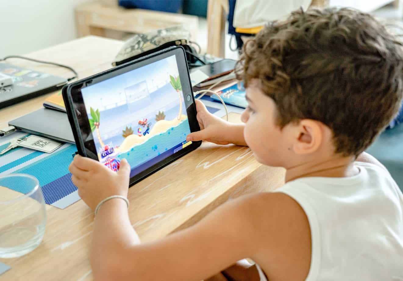 kid playing game on tablet
