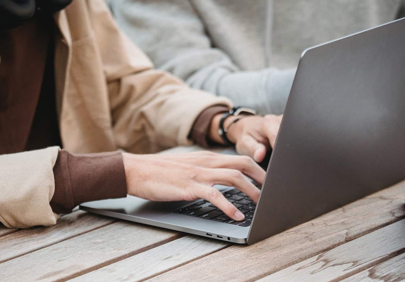 hands typing on laptop