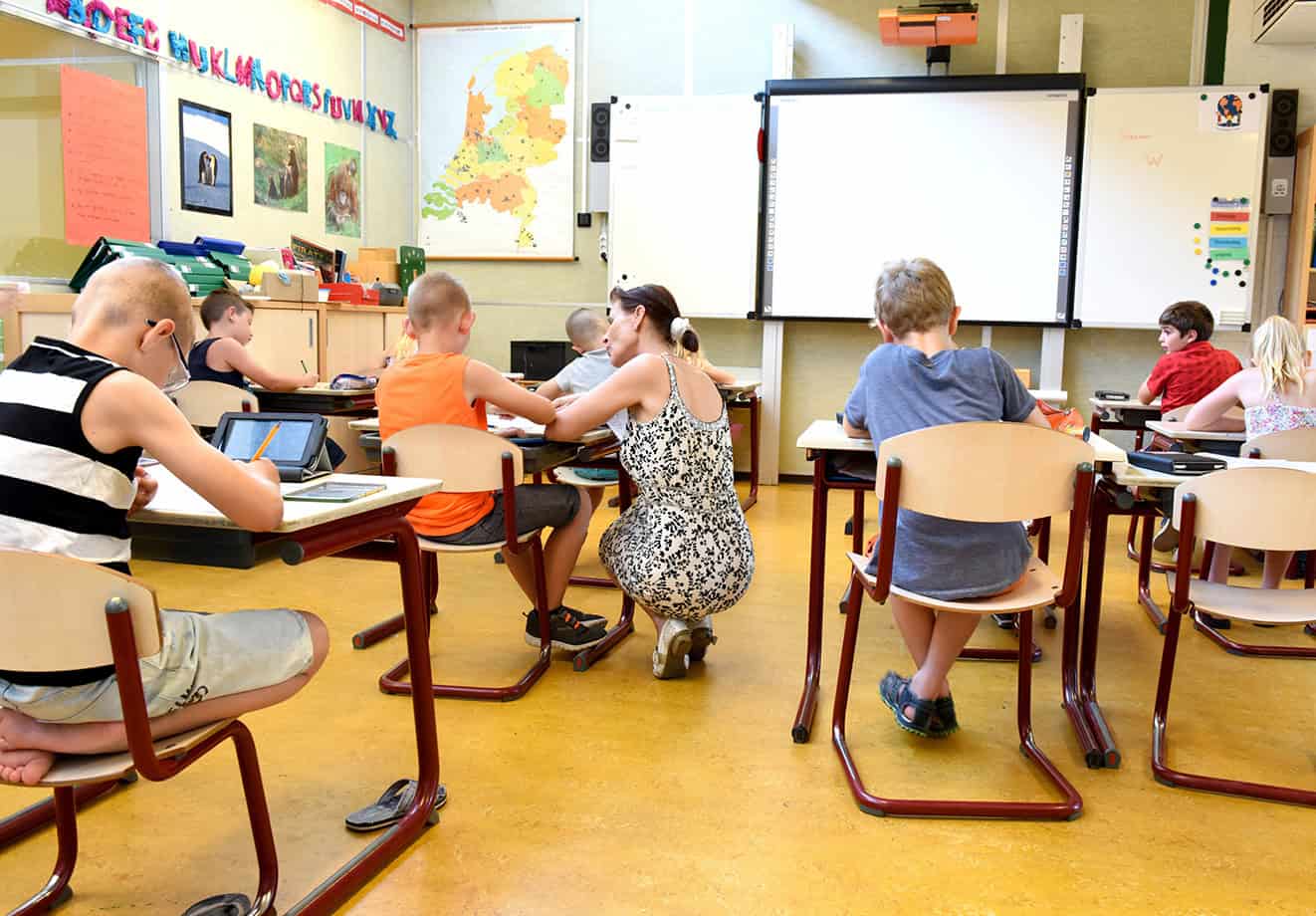 young students in classroom with teacher