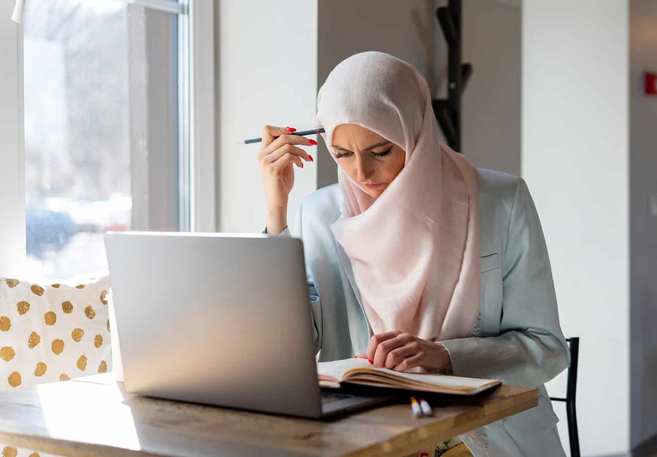 woman at table on laptop