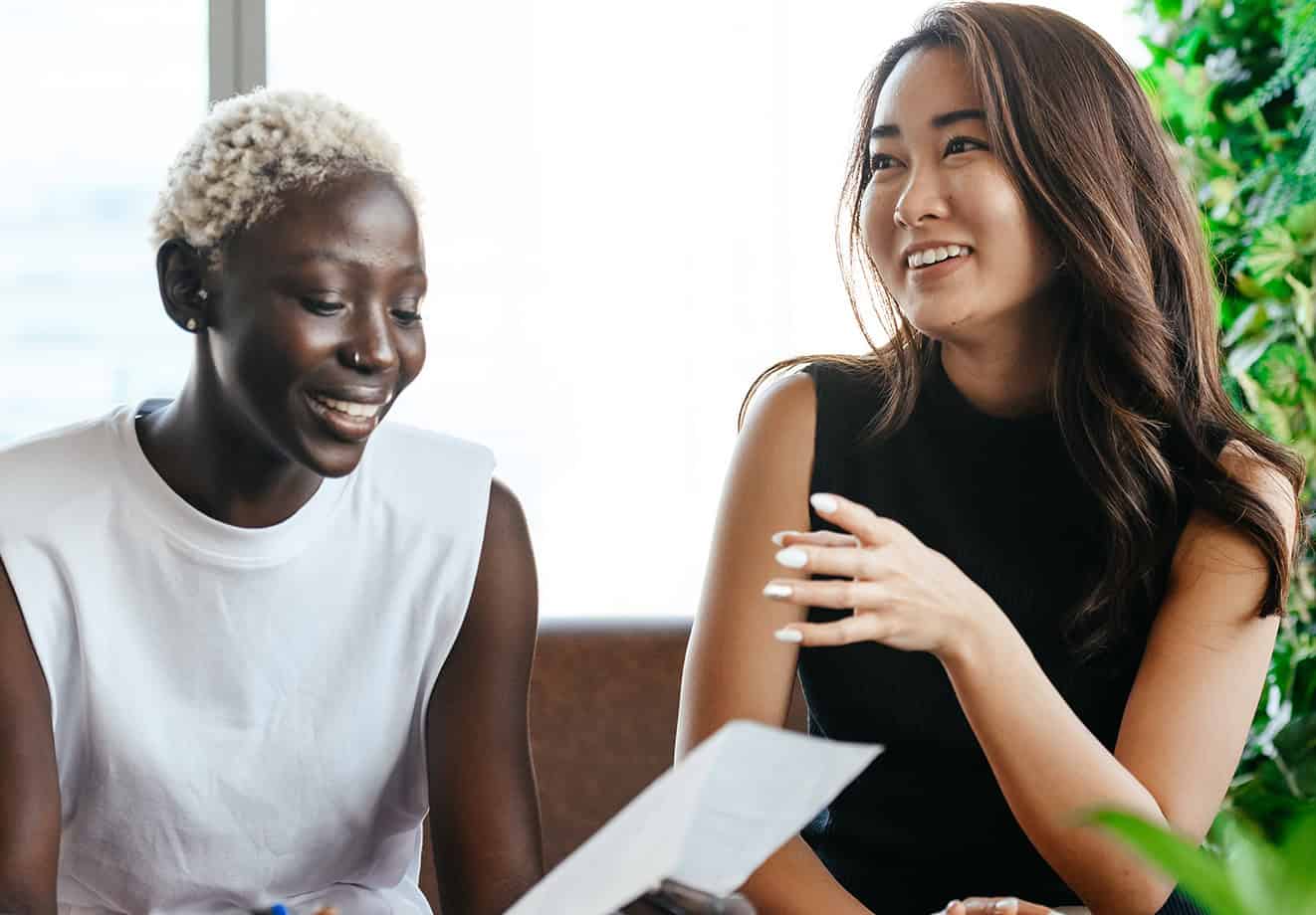 two teachers chatting about a paper on professional learning