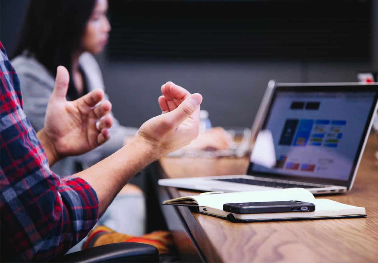 people working at a table with computers