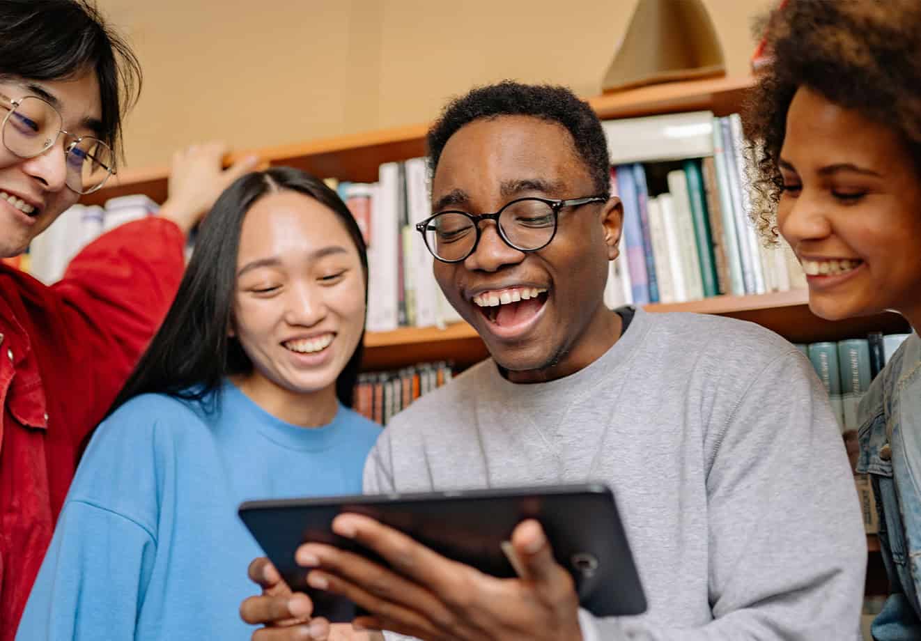 four college students using a tablet