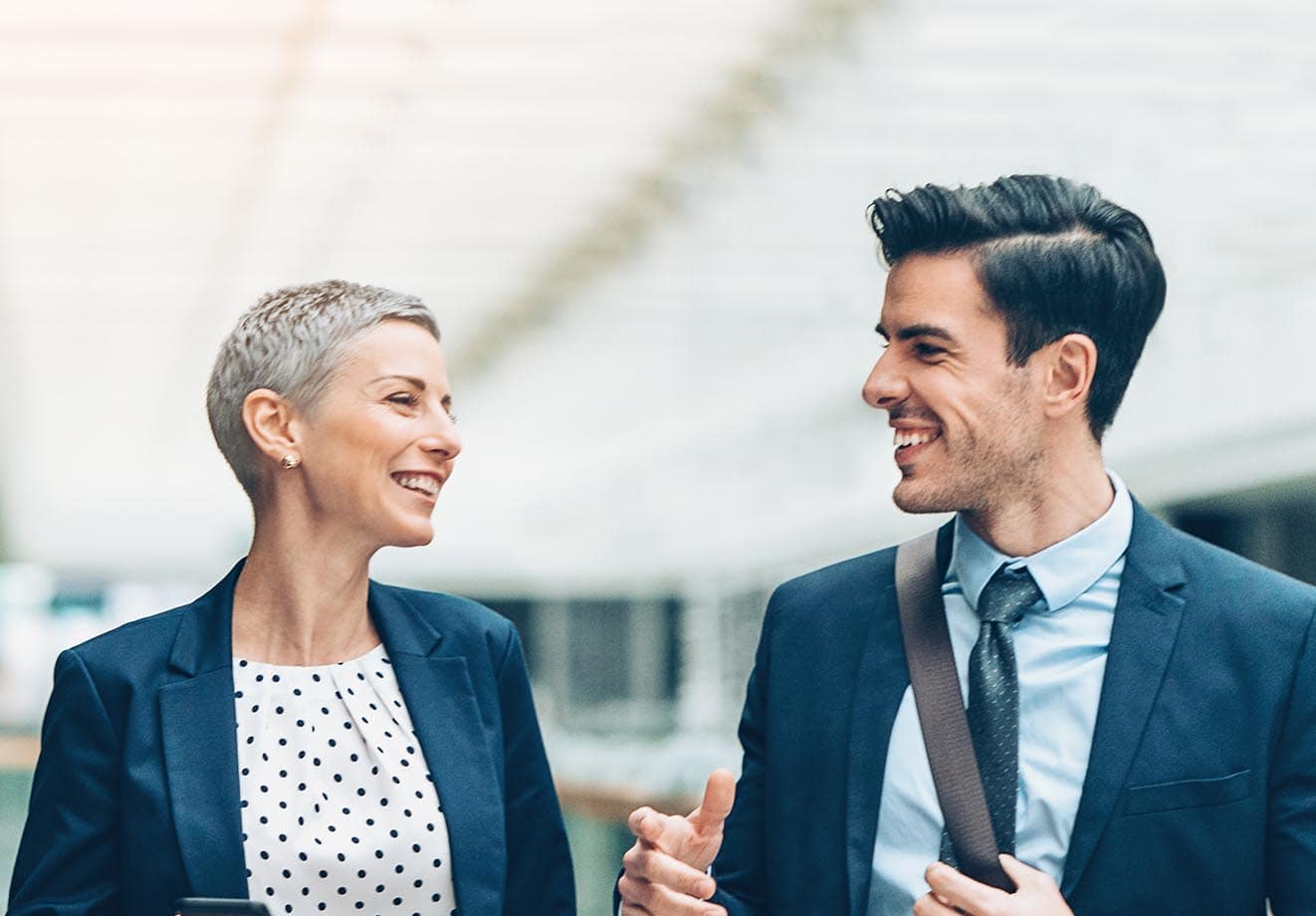 Two workers chatting and smiling