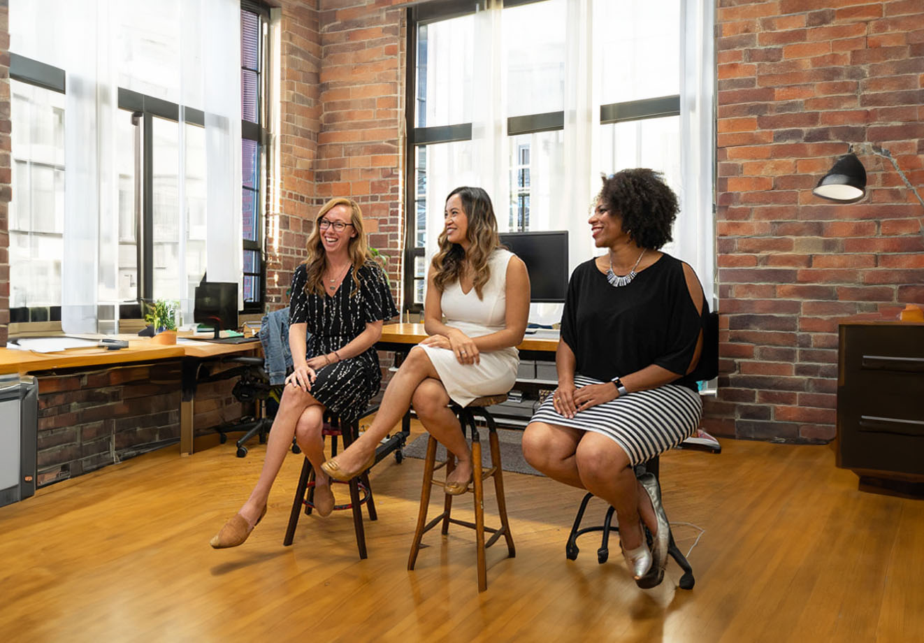 Three women giving a presentation in an office