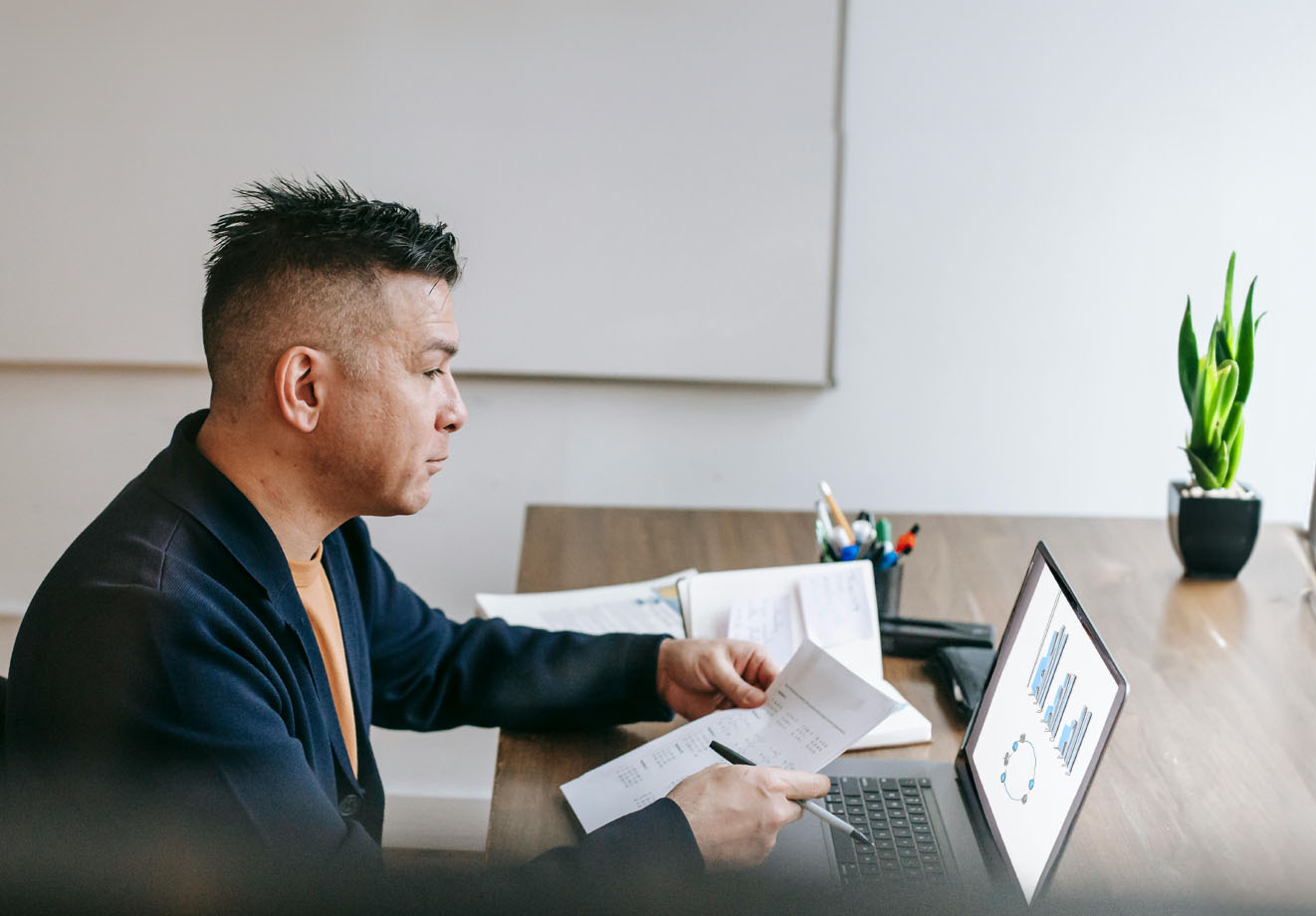 Man sitting at desk working on a laptop