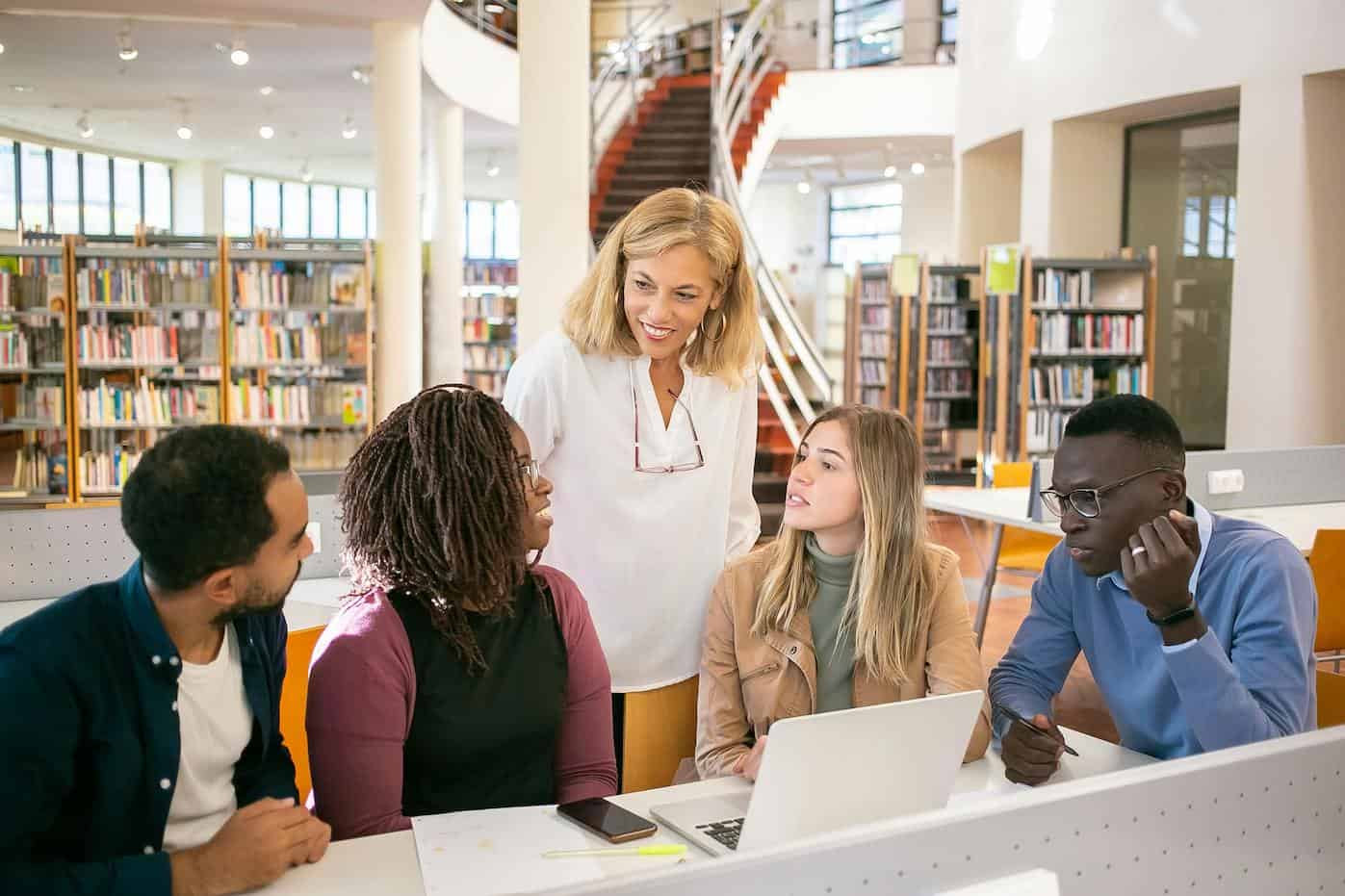 students learning with faculty member
