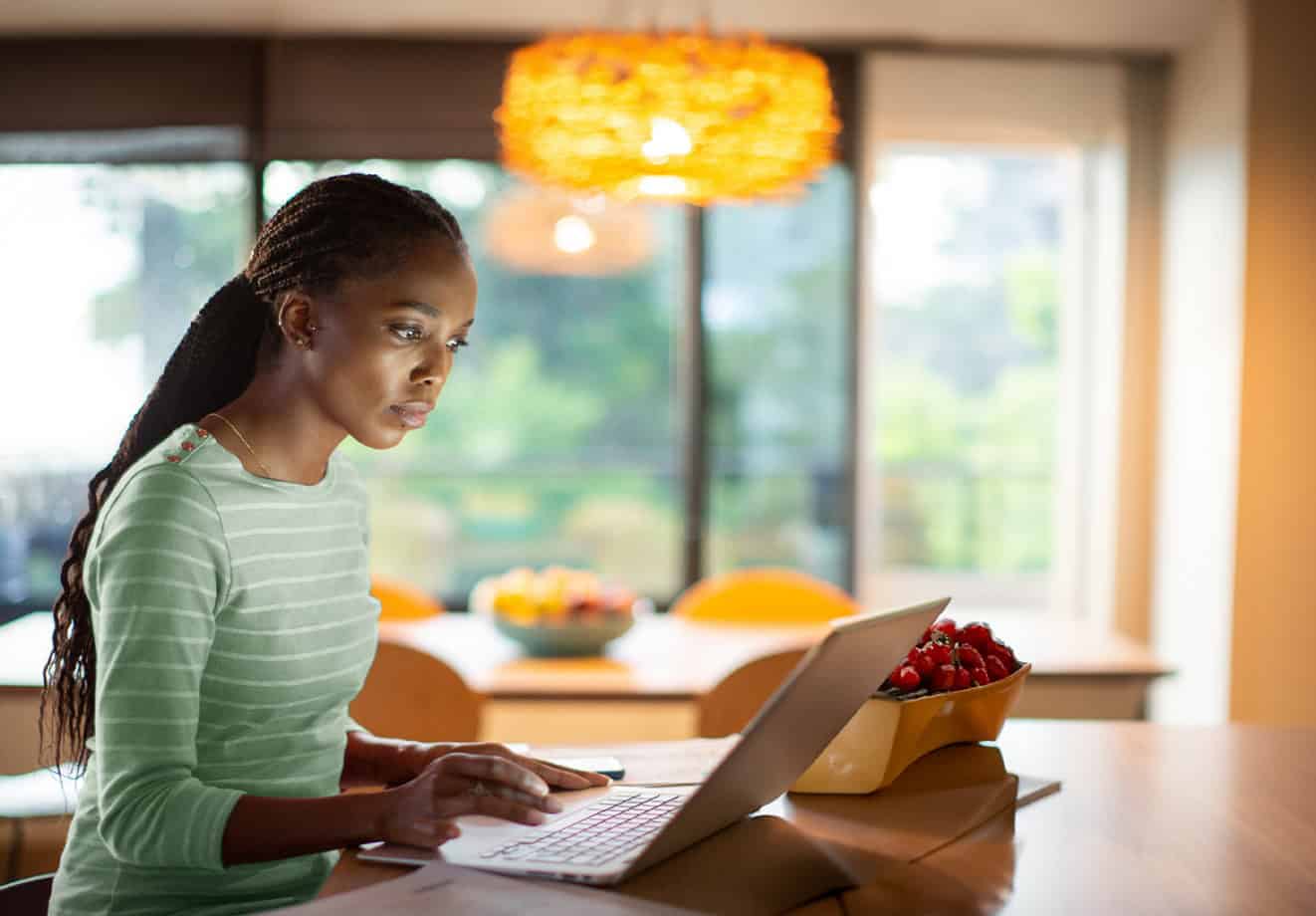 Woman typing on laptop at table