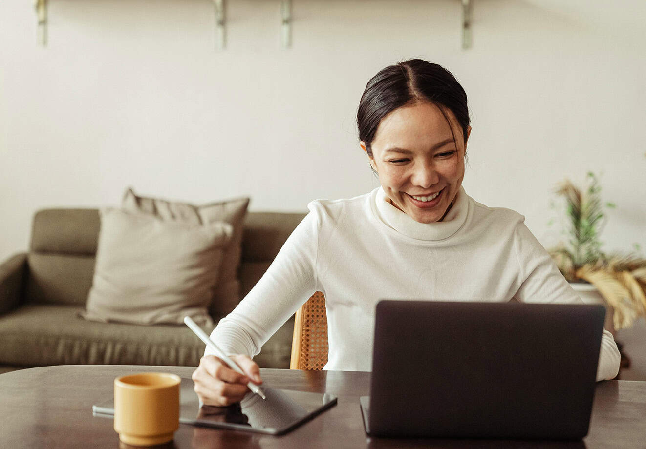 Woman working on laptop at table