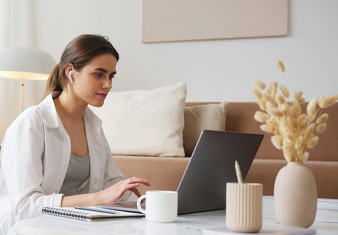 Student working on laptop at home desk