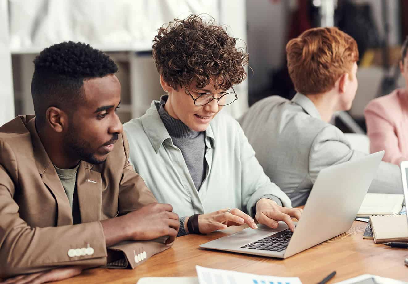 Two colleagues working on computer together