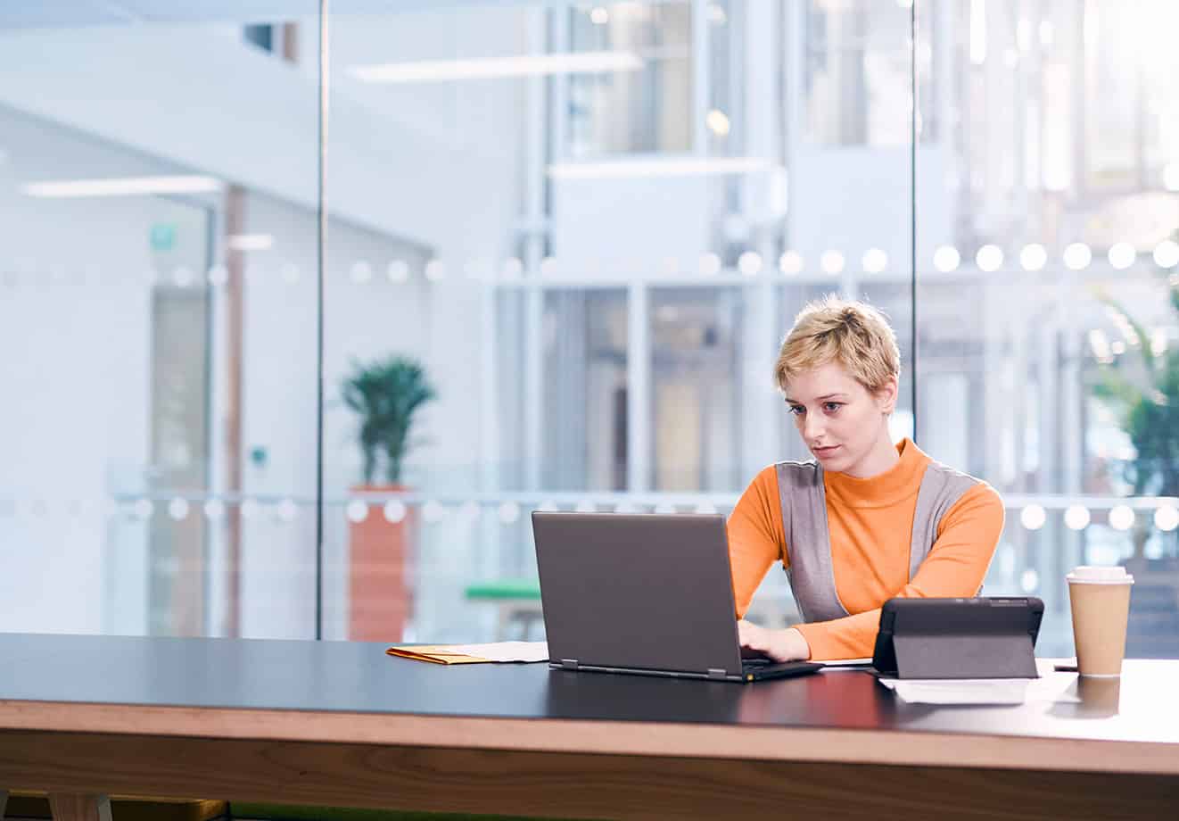 Woman working on laptop at desk