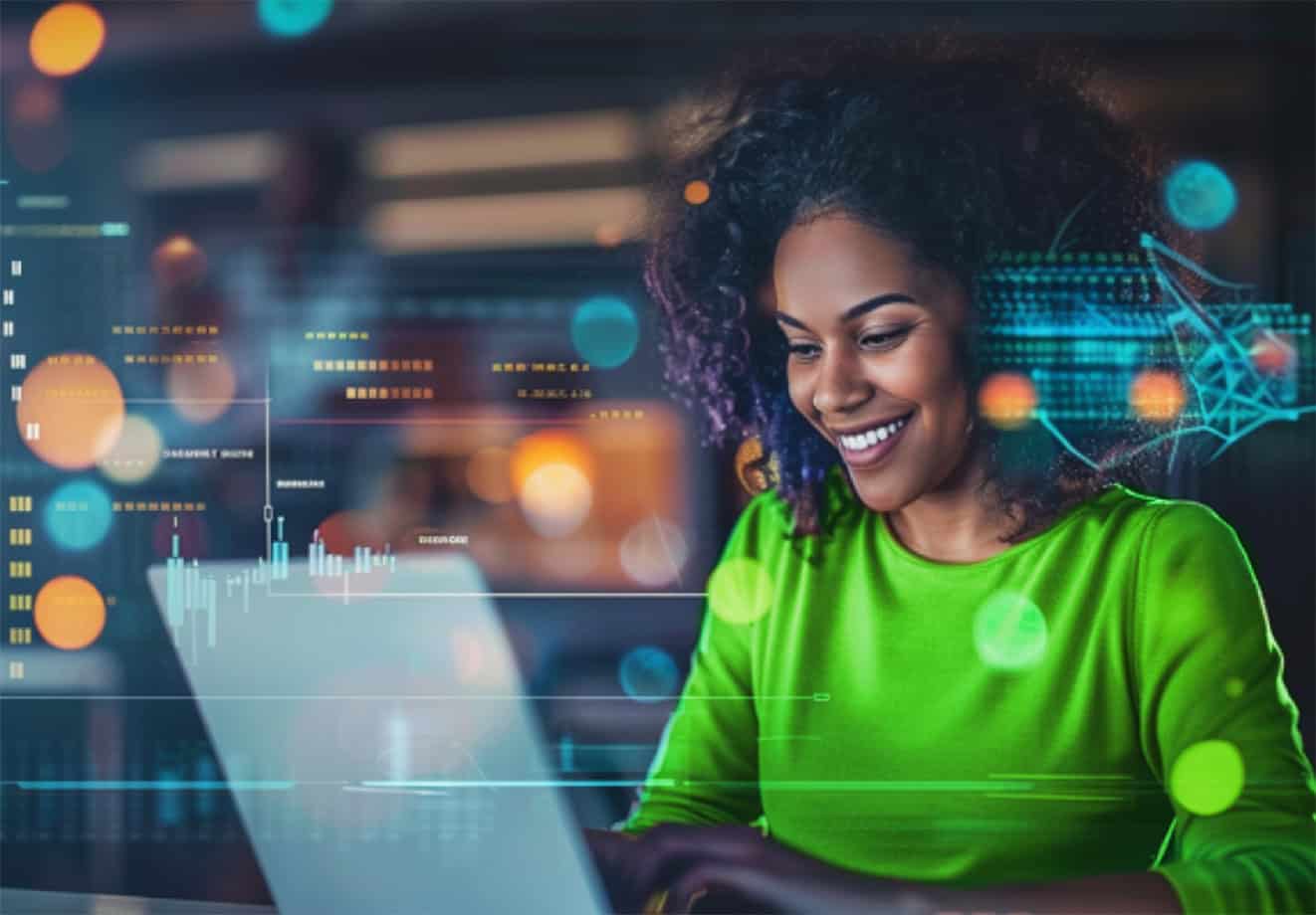 Woman typing on laptop and smiling at desk
