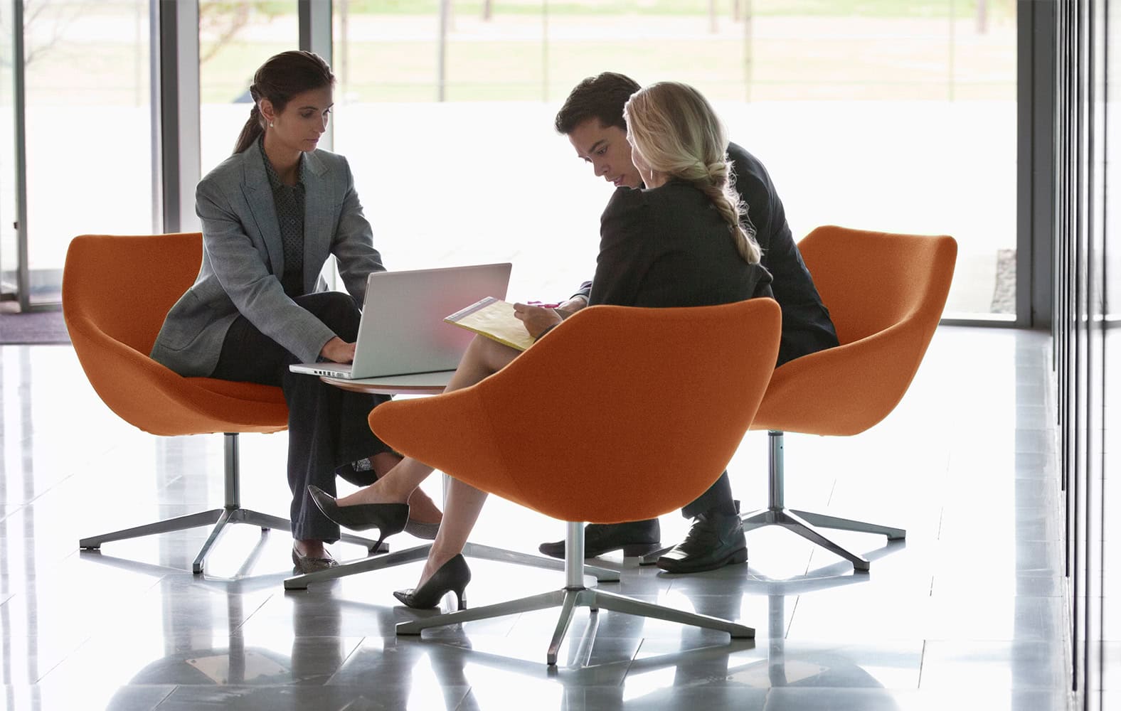Three professionals working together at a table