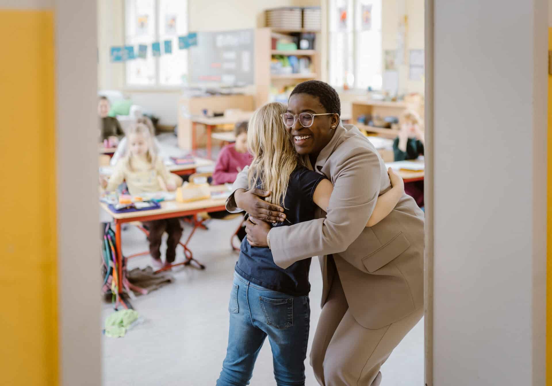 Teacher hugs student
