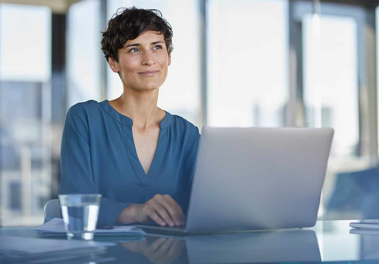 Smiling businesswoman working on laptop