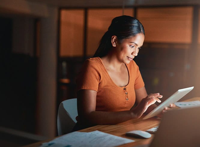 Woman working on tablet in office space