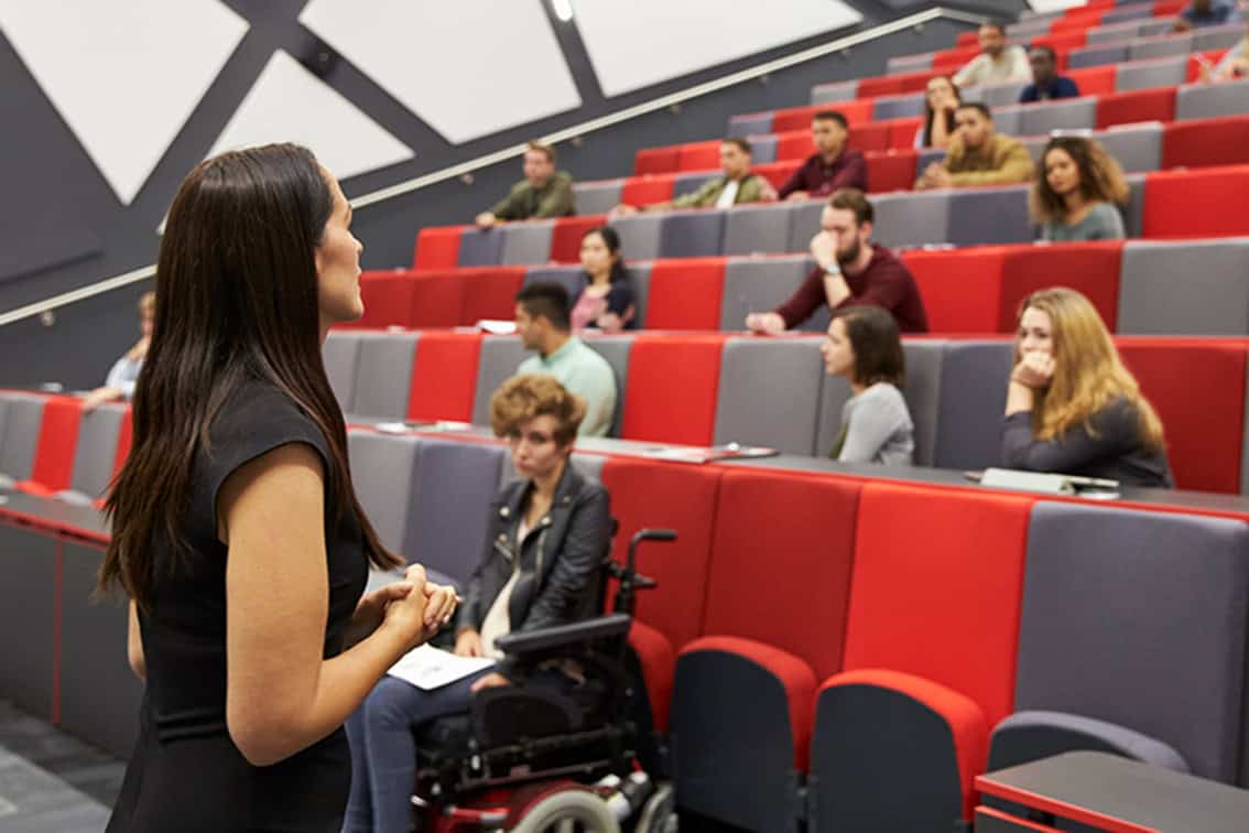 Professor giving lecture in lecture hall.