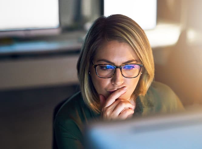 Woman looking at laptop focusing on work
