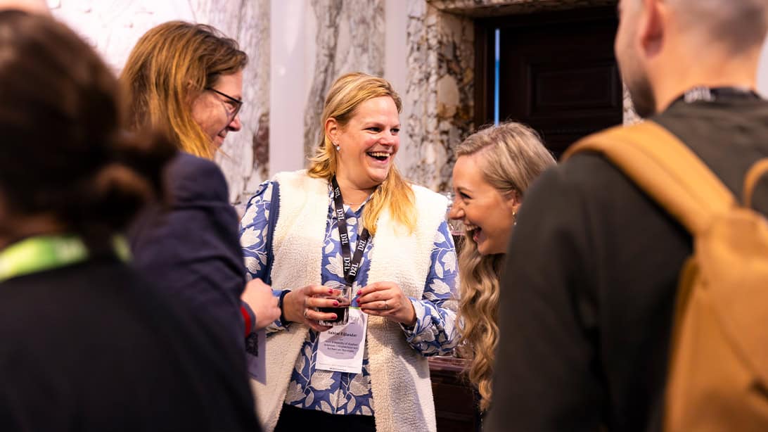 A group of professionals laughing at business convention