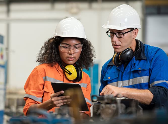Two construction workers looking at laptop
