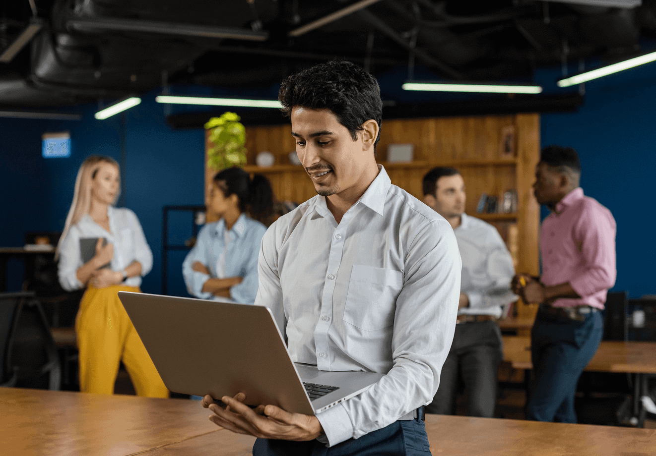 smiley man work holding laptop