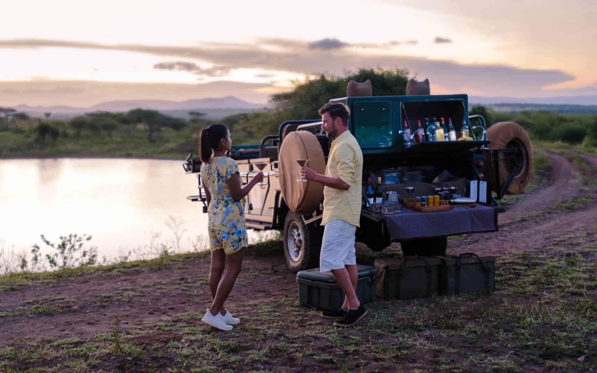 Man and woman on Game drive in Kruger National Park South Africa | Photo: fokkebok via Getty